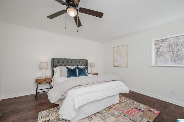 bedroom with ceiling fan, ornamental molding, and dark hardwood / wood-style flooring