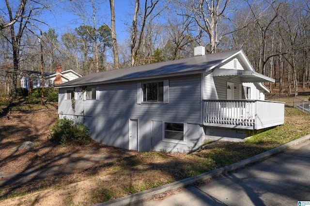 view of side of property featuring covered porch