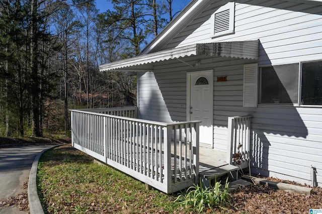 view of exterior entry featuring a deck