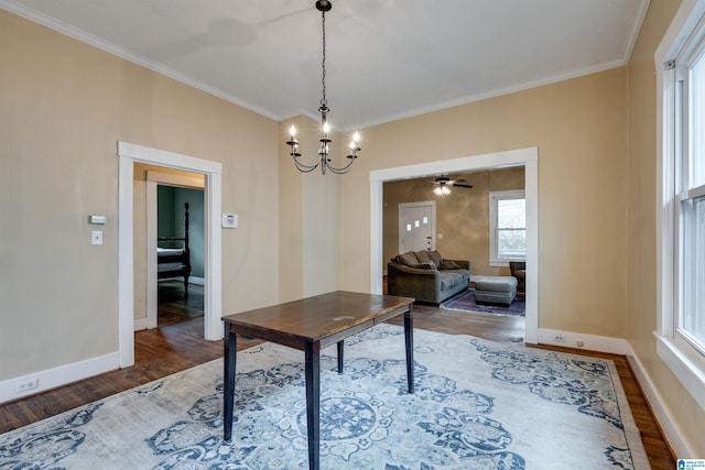 interior space featuring hardwood / wood-style flooring, crown molding, and a notable chandelier