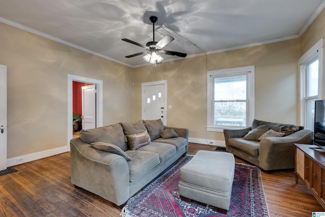 living room featuring dark hardwood / wood-style flooring, crown molding, and ceiling fan