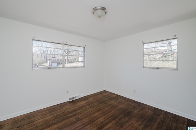 spare room with hardwood / wood-style flooring