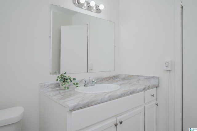 bathroom with toilet and vanity