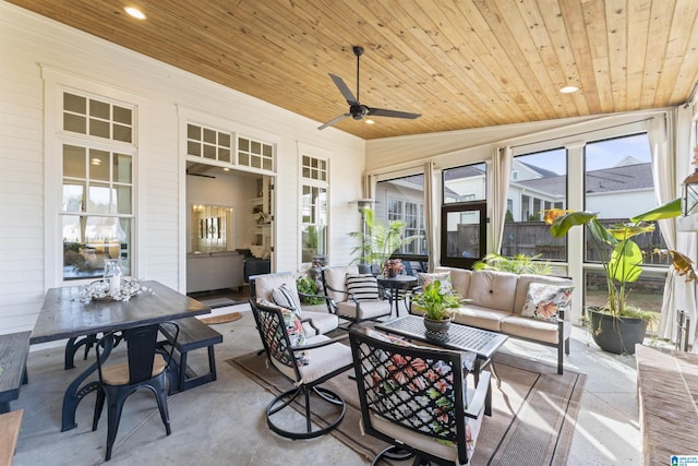 sunroom featuring ceiling fan, plenty of natural light, and wood ceiling