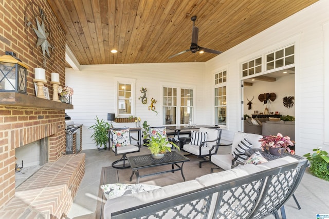 view of patio / terrace featuring ceiling fan and an outdoor living space with a fireplace