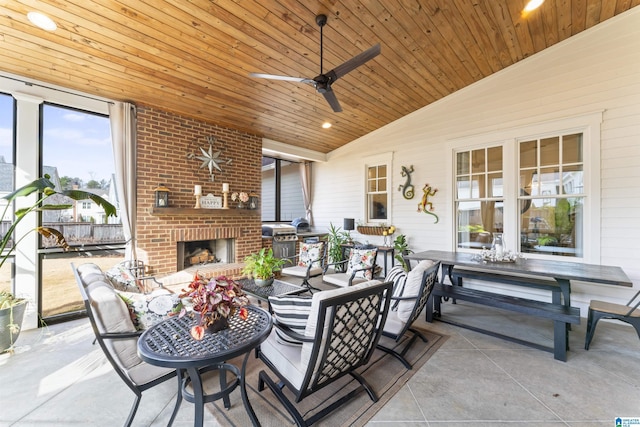 view of patio featuring area for grilling, an outdoor living space with a fireplace, and ceiling fan