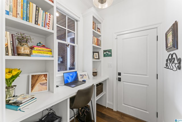 office with built in desk and dark hardwood / wood-style flooring