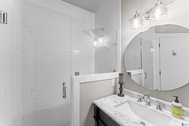 bathroom with vanity and a shower with shower door