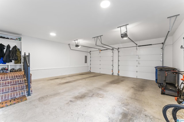 garage featuring a garage door opener and electric panel