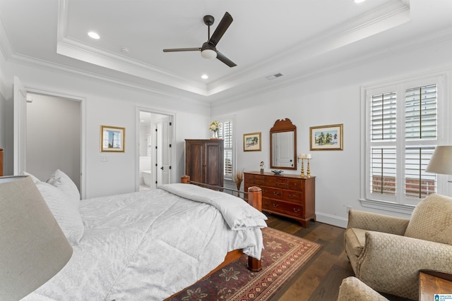 bedroom with a raised ceiling, ornamental molding, and dark hardwood / wood-style flooring