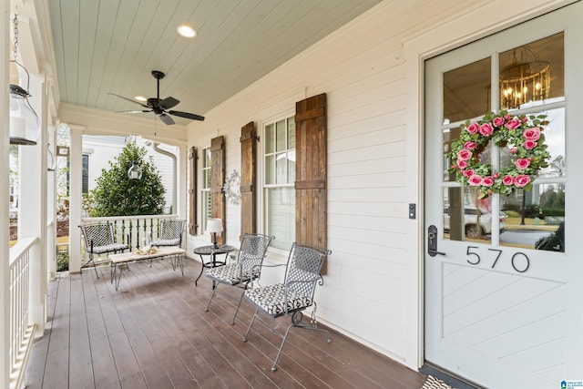 wooden deck with a porch and ceiling fan