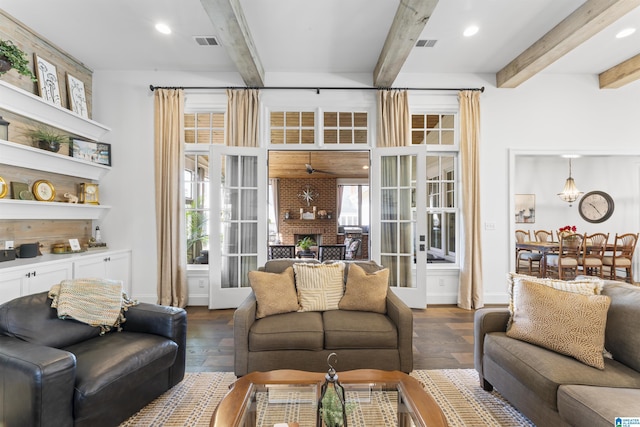 living room with dark hardwood / wood-style floors, a fireplace, and beam ceiling