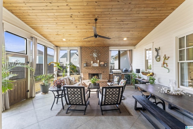 sunroom / solarium with lofted ceiling, wood ceiling, and a healthy amount of sunlight