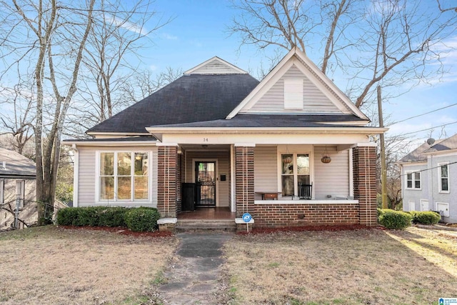 view of front of house featuring covered porch and a front lawn