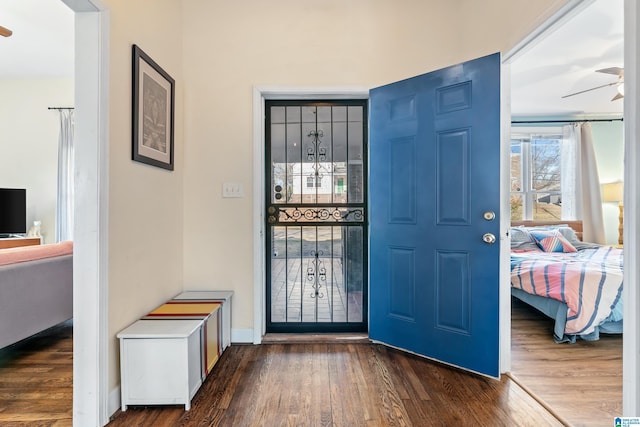 entryway featuring ceiling fan and dark wood-type flooring