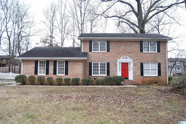 colonial home with a front lawn