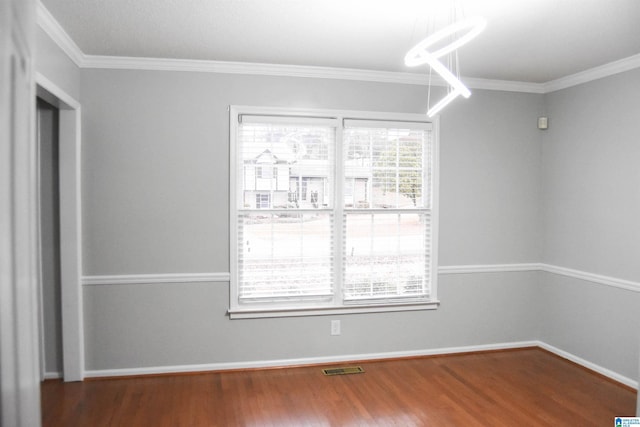 unfurnished room with crown molding and hardwood / wood-style floors