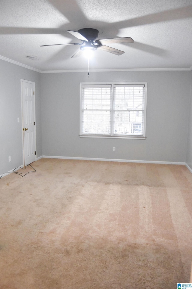 unfurnished room featuring ceiling fan, light colored carpet, a textured ceiling, and ornamental molding