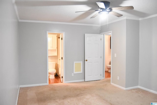 unfurnished bedroom with ensuite bathroom, light colored carpet, ceiling fan, and ornamental molding