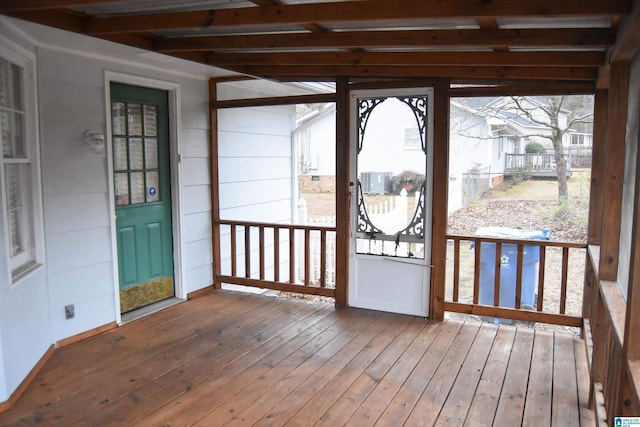 unfurnished sunroom with beamed ceiling