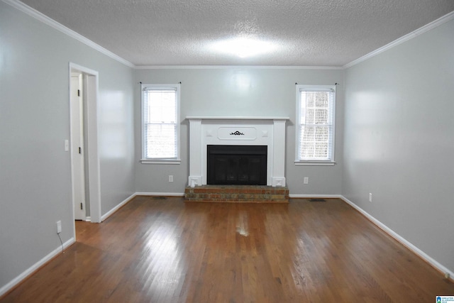 unfurnished living room with a textured ceiling, dark hardwood / wood-style flooring, crown molding, and a fireplace