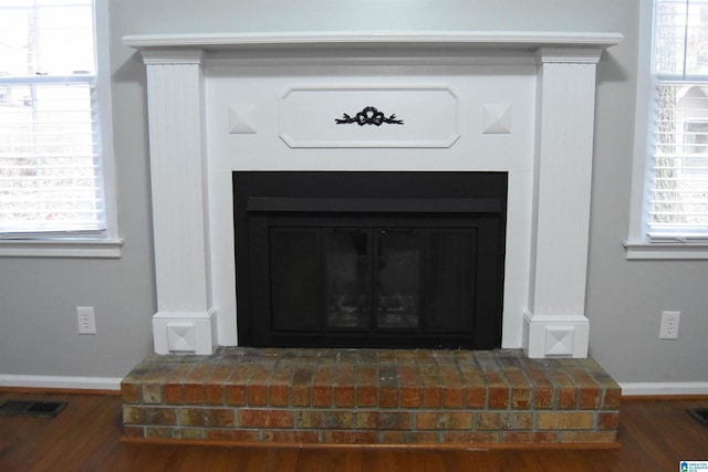 interior details featuring hardwood / wood-style floors and a fireplace