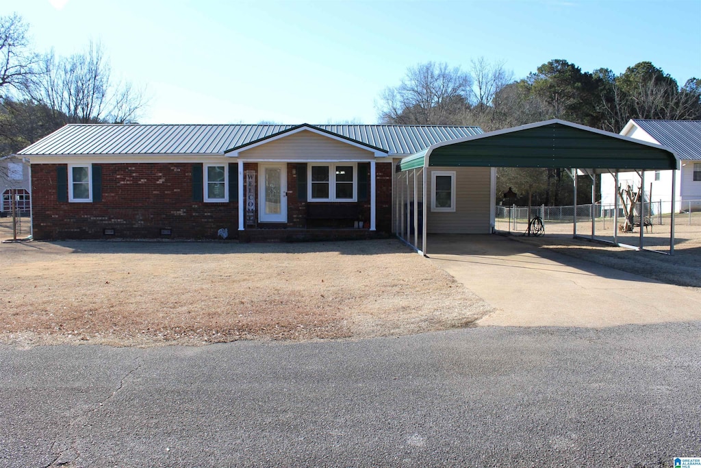 ranch-style home featuring a carport