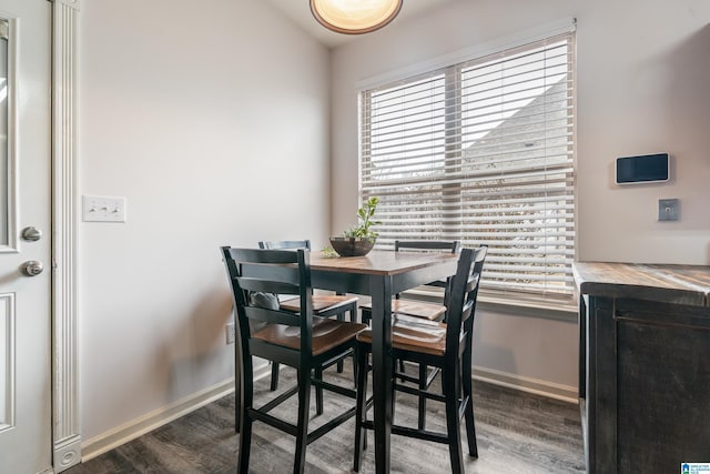 dining area with dark wood-type flooring and lofted ceiling