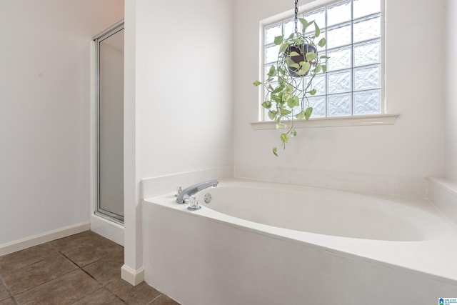 bathroom with shower with separate bathtub, a notable chandelier, and tile patterned flooring