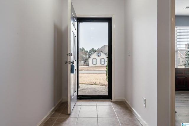 doorway with light tile patterned floors