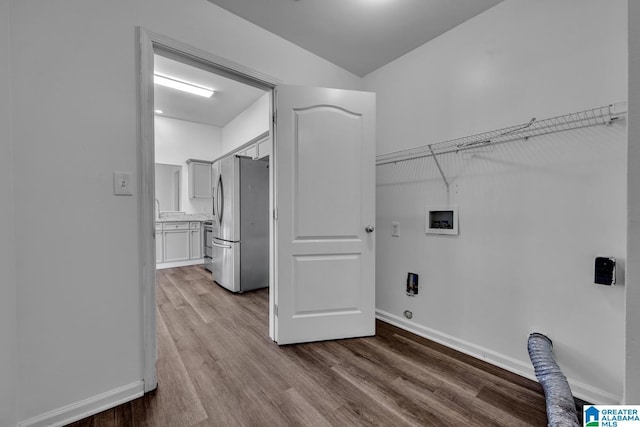 clothes washing area with washer hookup and light wood-type flooring