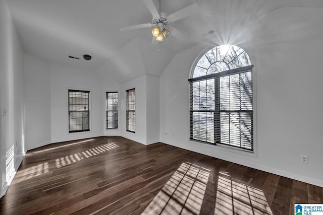 empty room featuring ceiling fan, plenty of natural light, and dark hardwood / wood-style flooring