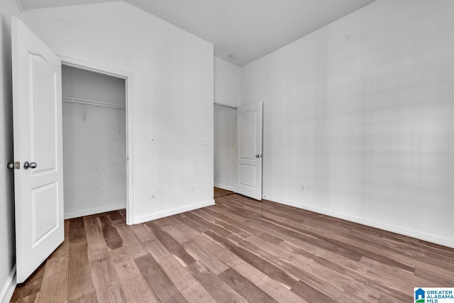 unfurnished bedroom featuring a closet and hardwood / wood-style flooring