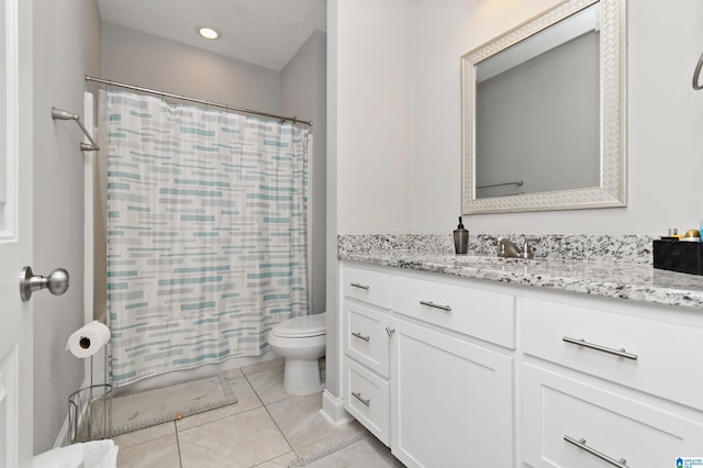 bathroom featuring toilet, tile patterned floors, and vanity