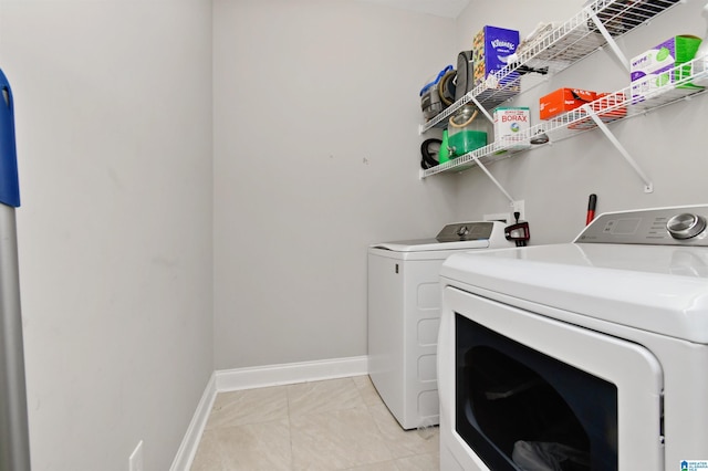 laundry area featuring light tile patterned floors and independent washer and dryer