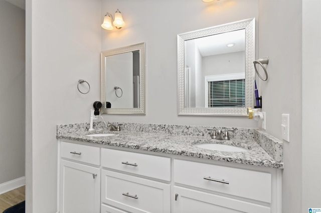 bathroom with vanity and hardwood / wood-style floors