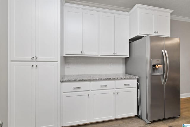 kitchen with white cabinets, light wood-type flooring, stainless steel fridge with ice dispenser, and ornamental molding