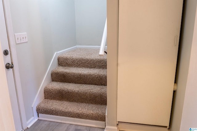 stairway featuring hardwood / wood-style floors