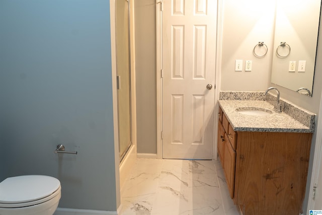 bathroom with vanity, an enclosed shower, and toilet