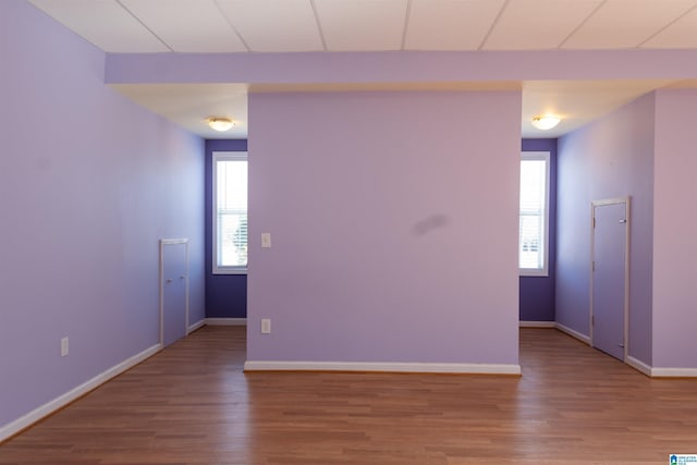 empty room with hardwood / wood-style flooring and plenty of natural light