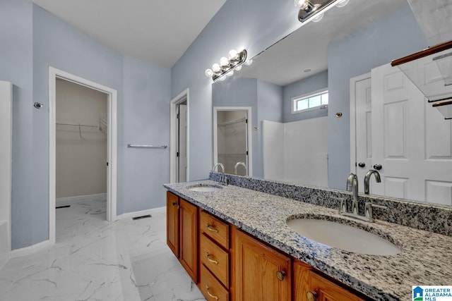 bathroom with vanity and a shower