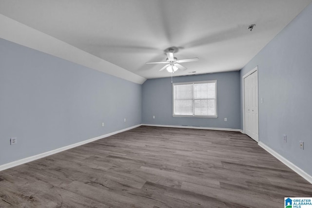 unfurnished room with lofted ceiling, hardwood / wood-style floors, and ceiling fan