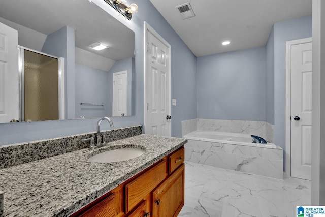 bathroom with vanity and separate shower and tub