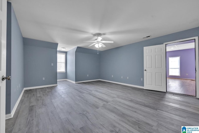 unfurnished room with ceiling fan, light hardwood / wood-style flooring, and a wealth of natural light