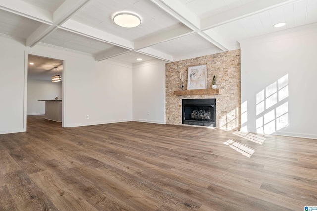 unfurnished living room with hardwood / wood-style flooring, coffered ceiling, and beamed ceiling