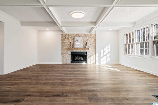 unfurnished living room featuring coffered ceiling, a large fireplace, hardwood / wood-style flooring, and beamed ceiling