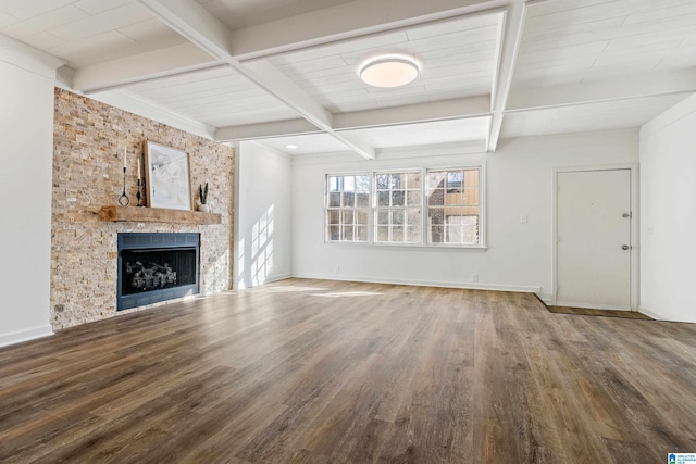 unfurnished living room with a fireplace, beamed ceiling, and hardwood / wood-style floors