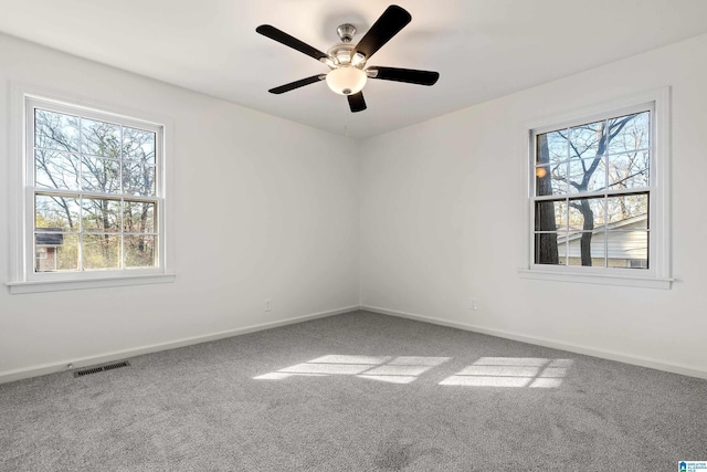 empty room featuring ceiling fan and carpet flooring