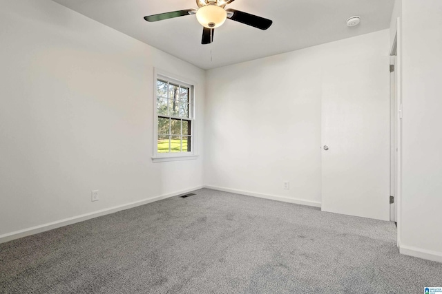 carpeted empty room featuring ceiling fan