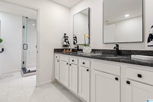 bathroom featuring walk in shower and vanity